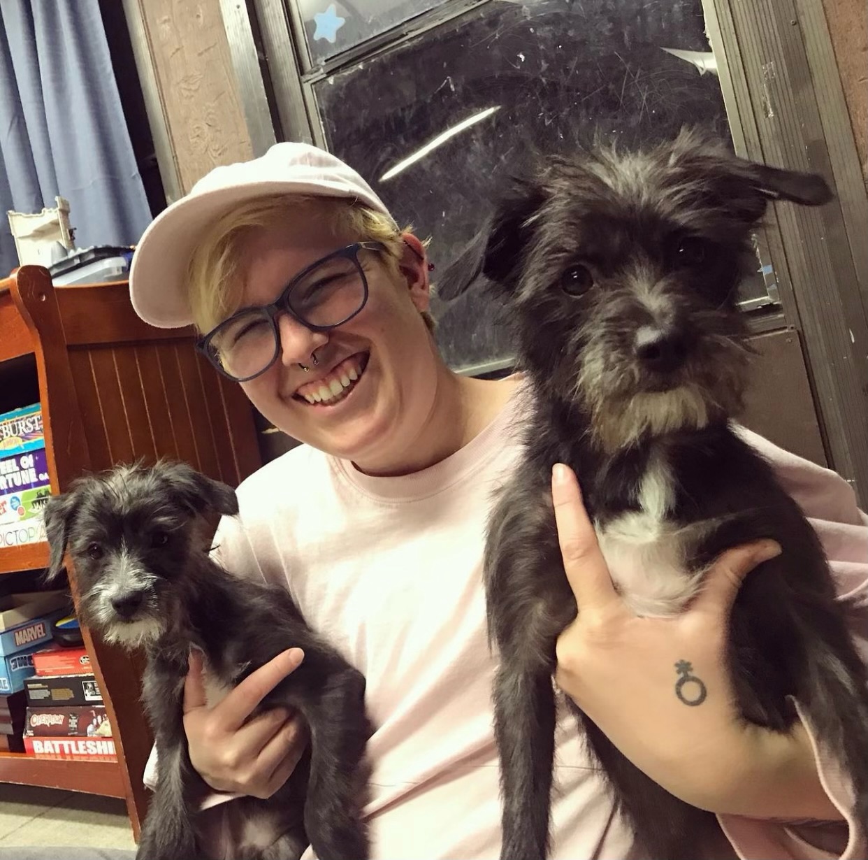 Sammi Holding Two Dogs